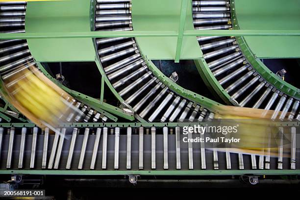 boxes on conveyor belt, elevated view - nahrungsmittelfabrik stock-fotos und bilder