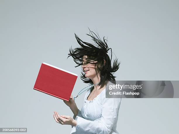 young woman reading book, side view - smart studio shot stock pictures, royalty-free photos & images