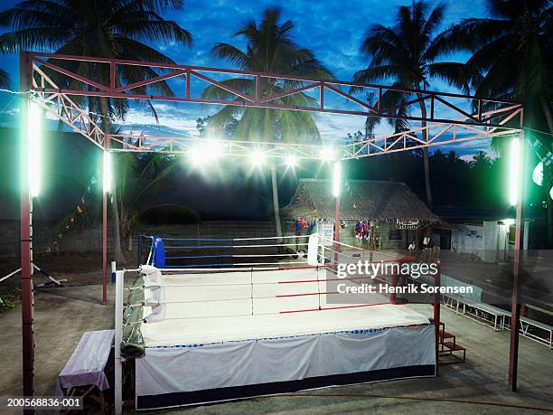 empty thai boxing ring illuminated at evening - boxing ring empty stock pictures, royalty-free photos & images