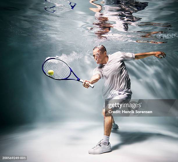 young man underwater playing tennis - crazy pool foto e immagini stock