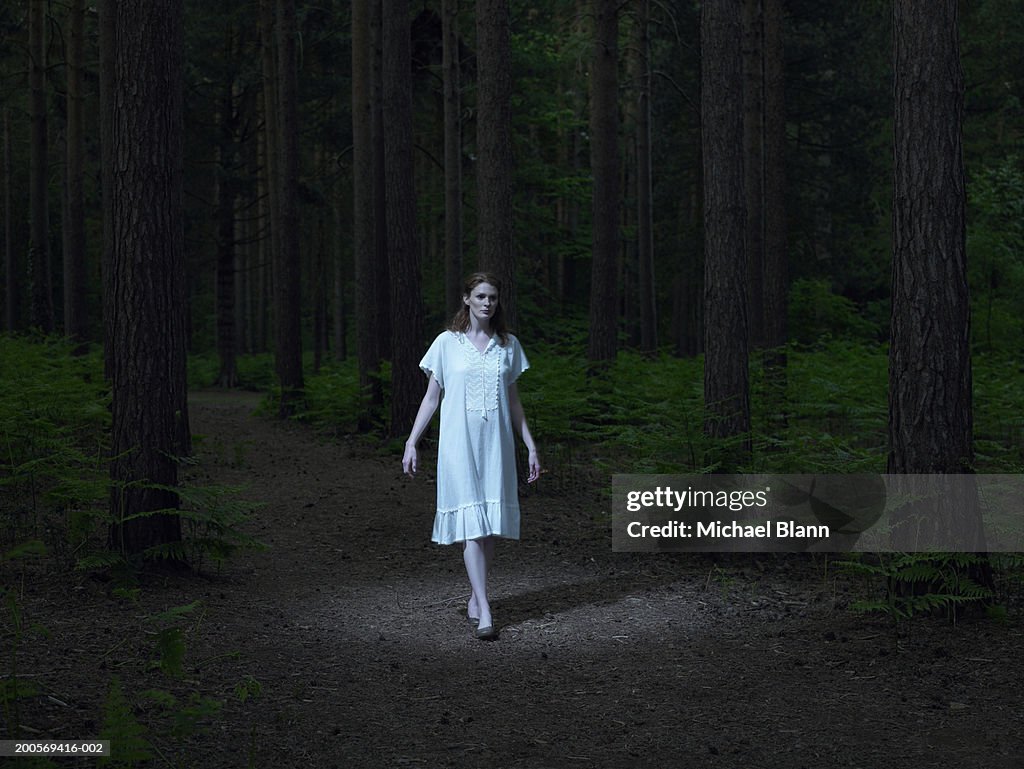 Young woman walking in forest