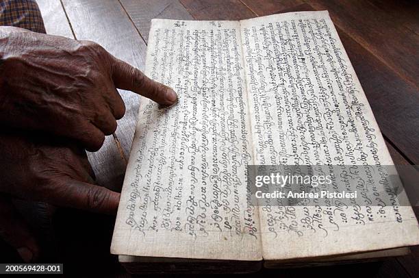 senior man reading manuscript, close up - manuscript stock pictures, royalty-free photos & images