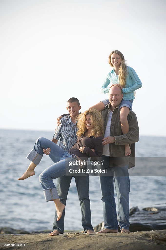 Family at beach, smiling