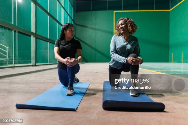 young women enjoying an evening yoga session - mexico training session stock pictures, royalty-free photos & images