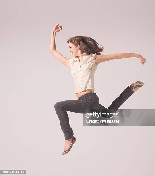 young woman running in air, side view - top priority stock pictures, royalty-free photos & images