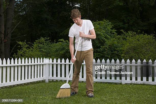 man sweeping lawn with broom - 掃地 個照片及圖片檔