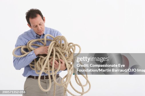 Mature Man Holding Entangled Rope High-Res Stock Photo - Getty Images