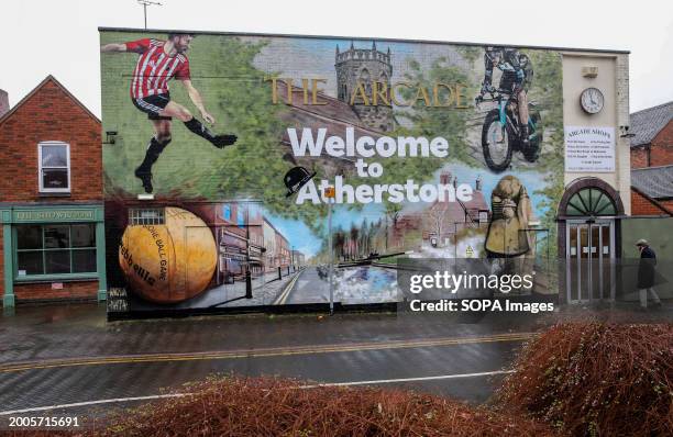 Billboard welcomes visitors to Atherstone with a mural highlighting the things the town is famous for , including the ball game. Players gather...