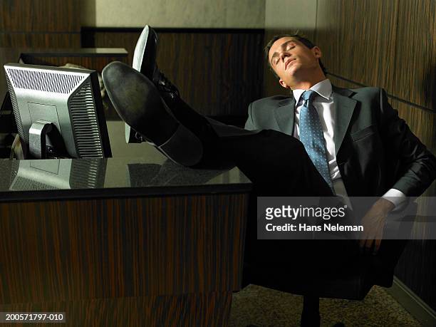 businessman asleep at desk, night - feet on table bildbanksfoton och bilder