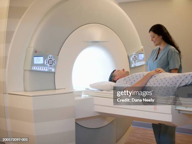 male patient undergoing cat scan - cat scan machine stock pictures, royalty-free photos & images