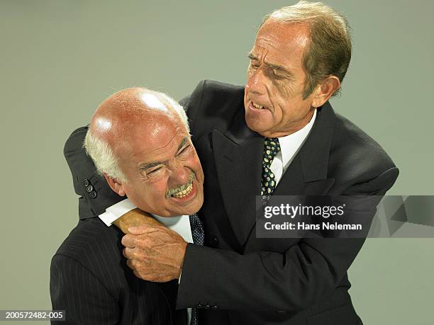 two senior business men fighting, studio shot - men wrestling stock pictures, royalty-free photos & images