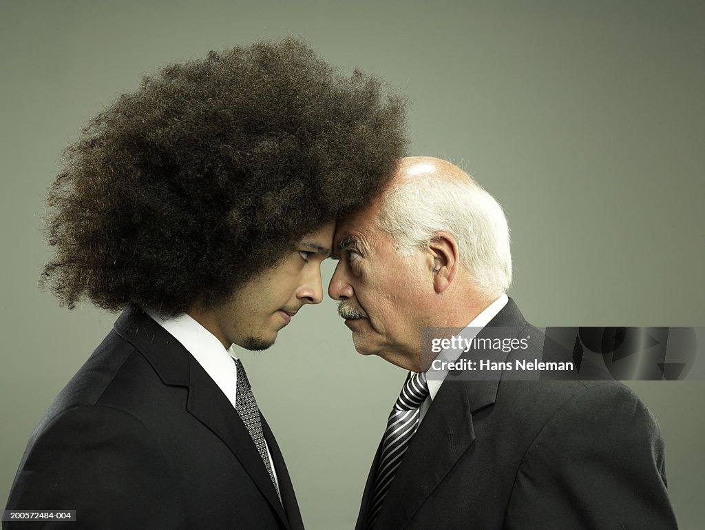 Two business men head to head, studio shot