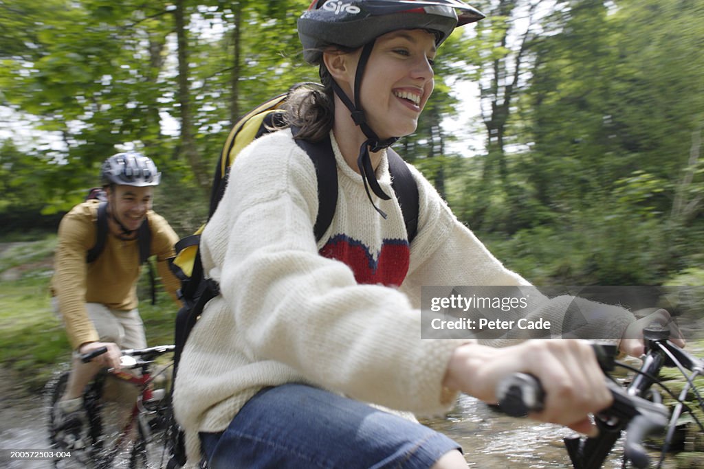 Couple riding bicycles in countryside