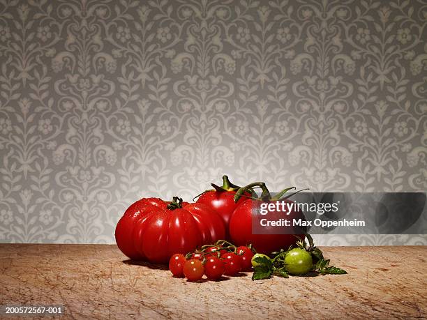 various tomatoes on chopping board - beefsteak tomato stock pictures, royalty-free photos & images