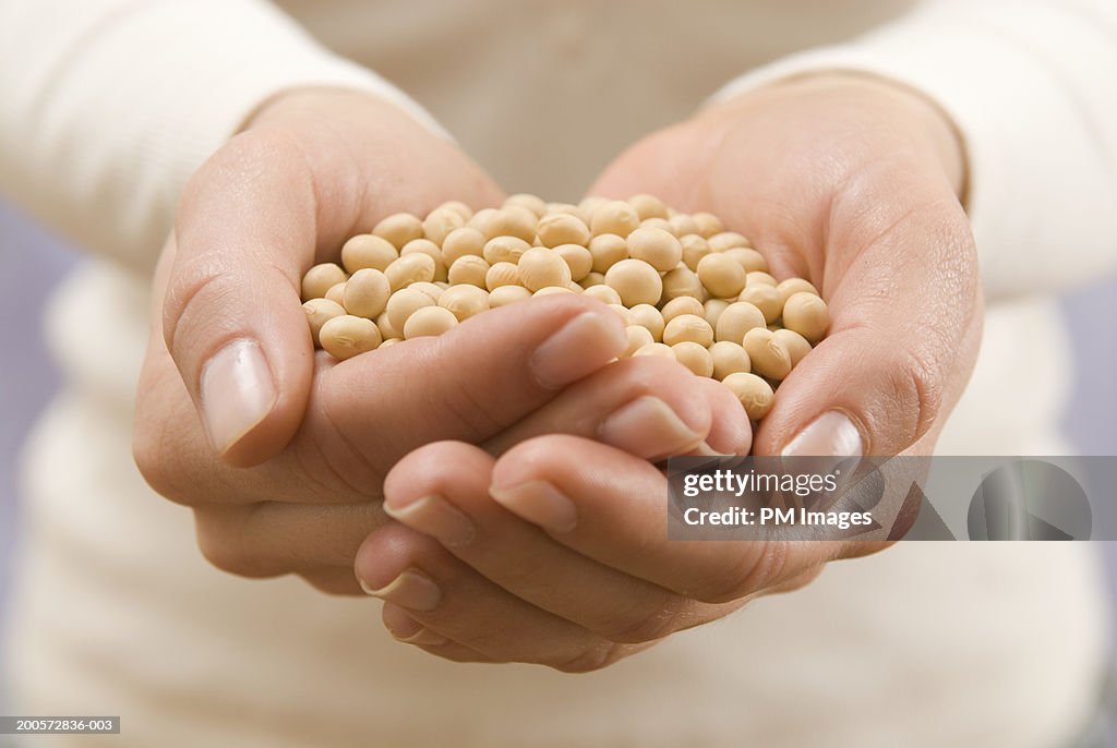 Woman holding soy beans, close-up