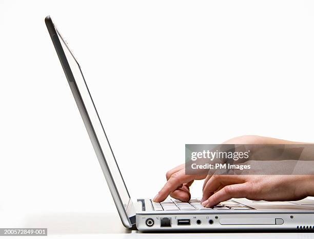 woman using laptop, side view, close-up - laptop side view stock pictures, royalty-free photos & images