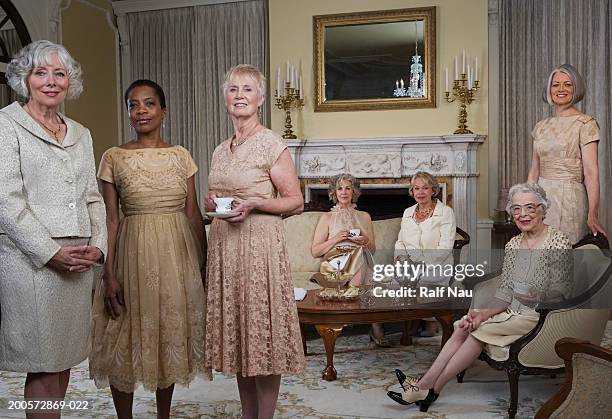 senior and mature women at tea party, portrait - gutes benehmen stock-fotos und bilder