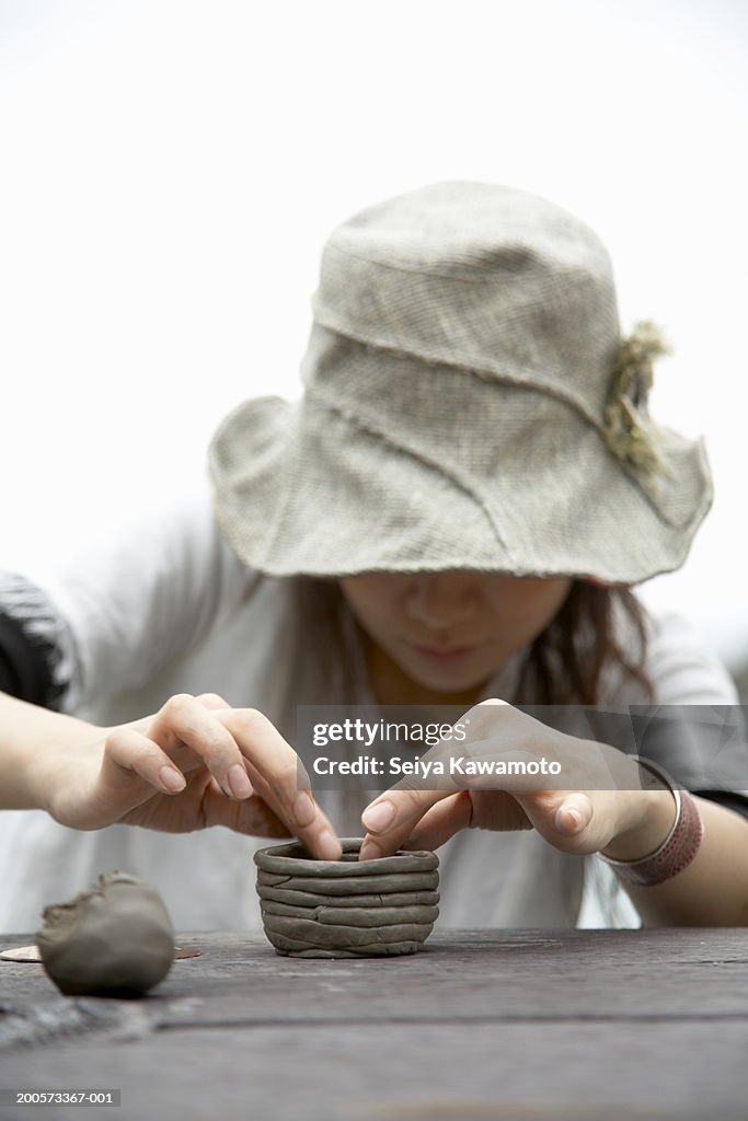 Woman moulding clay