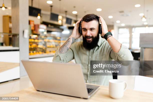 smiling businessman wokring at cafe - wokring out stock pictures, royalty-free photos & images