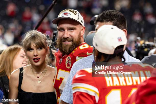 Travis Kelce of the Kansas City Chiefs and Taylor Swift react as they see Mecole Hardman Jr. #12 of the Kansas City Chiefs following the NFL Super...