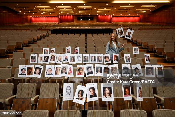 Staff member lays out heads on sticks marking the EE BAFTA Film Awards 2024 seating plan during the "Heads On Sticks" photocall ahead of the EE BAFTA...