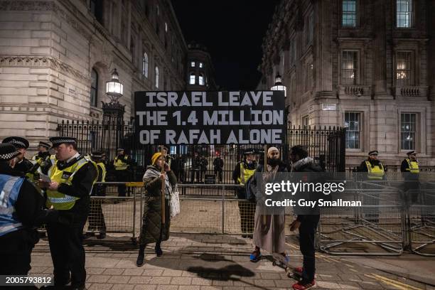 Protestor hold a banner at Downing Street on February 12, 2024 in London, England. Stop The War Coalition and other pro-Palestinian groups are...