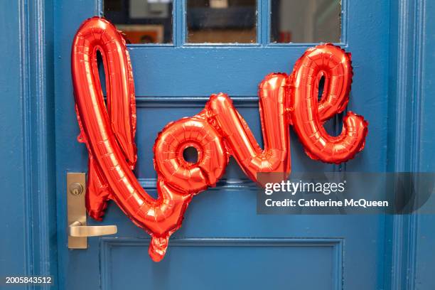 love balloon on blue door - wedding symbols stock pictures, royalty-free photos & images