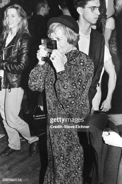 Baroness Sherry Von Korber-Bernstein takes a photograph at the Love Machine nightclub, New York, New York, April 11, 1990.