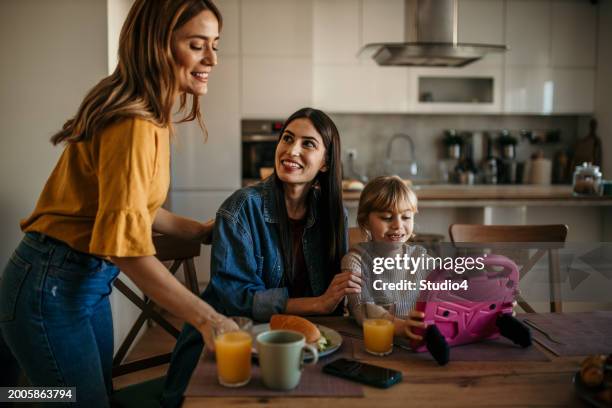 digital learning at home - family clearing dinner table stock pictures, royalty-free photos & images