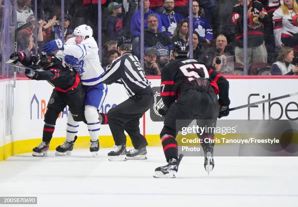 Morgan Rielly of the Toronto Maple Leafs stands over Ridly Greig of the Ottawa Senators after being cross checked in the head following his empty net...