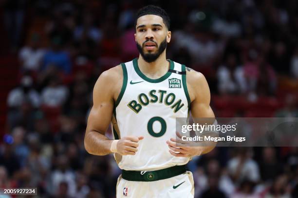 Jayson Tatum of the Boston Celtics looks on against the Miami Heat during the first quarter of the game at Kaseya Center on February 11, 2024 in...