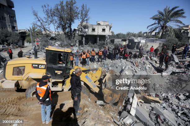 Civil defense teams and Palestinians conduct search and rescue operations among the rubbles of the destroyed buildings after Israeli attacks on the...