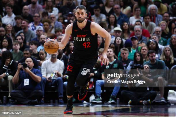 Kevin Love of the Miami Heat dribbles the ball against the Boston Celtics during the third quarter of the game at Kaseya Center on February 11, 2024...