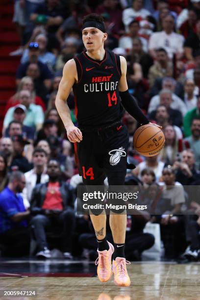 Tyler Herro of the Miami Heat dribbles the ball against the Boston Celtics during the third quarter of the game at Kaseya Center on February 11, 2024...