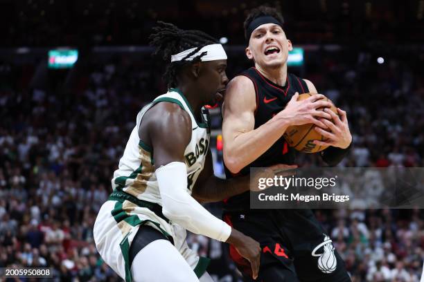 Tyler Herro of the Miami Heat drives against against Jrue Holiday of the Boston Celtics during the fourth quarter of the game at Kaseya Center on...