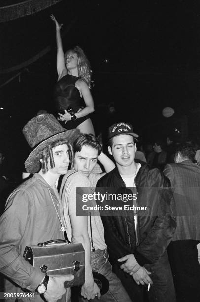 View of 'Club Kids', fore, from left, Robert Sorce , nightclub promotor Michael Alig , and DJ Keoki at the Roxy nightclub, New York, New York, April...