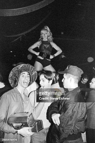 View of 'Club Kids', fore, from left, Robert Sorce , nightclub promotor Michael Alig , and DJ Keoki at the Roxy nightclub, New York, New York, April...