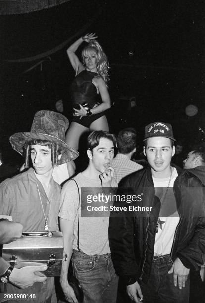 View of 'Club Kids', fore, from left, Robert Sorce , nightclub promotor Michael Alig , and DJ Keoki at the Roxy nightclub, New York, New York, April...