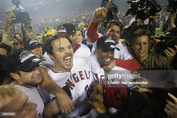 Scott Spiezio of the Anaheim Angels rejoices with teammates Adam Kennedy , Alex Ochoa and others after the victory over the San Francisco Giants in...