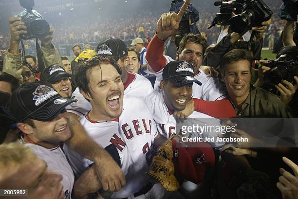 Scott Spiezio of the Anaheim Angels rejoices with teammates Adam Kennedy , Alex Ochoa and others after the victory over the San Francisco Giants in...