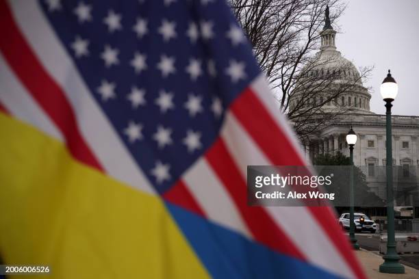 Man holds a mixed flag of Ukraine and America outside the U.S. Capitol on February 12, 2024 in Washington, DC. The Senate continues debate on the...
