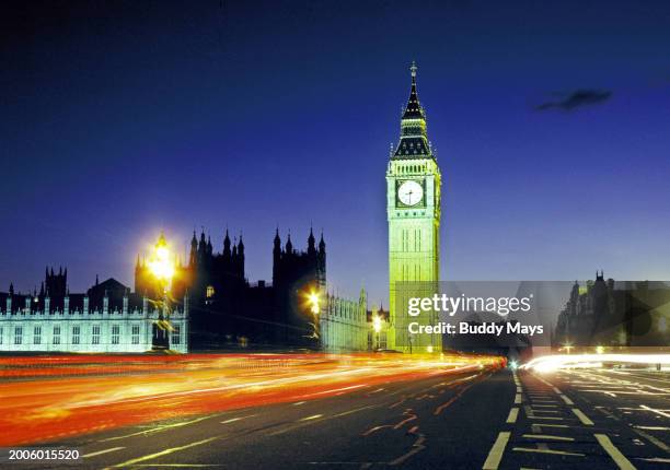 View of Big Ben at night from the Westminster Bridge along the Thames River at sunset, in London, England, United Kingdom, 1999. .