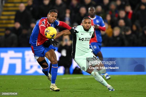 Christopher Nkunku of Chelsea is challenged by Matheus França of Crystal Palace during the Premier League match between Crystal Palace and Chelsea FC...