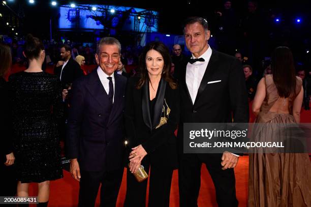 German actress Iris Berben poses with partner Heiko Kiesow and German author Michel Friedman on the red carpet prior to the opening ceremony of the...