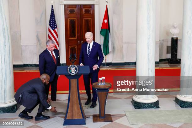 Staff member presents a step stool to for King of Jordan Abdullah II ibn Al Hussein to use during his remarks at the White House on February 12, 2024...