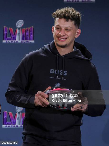 Quarterback Patrick Mahomes of the Kansas City Chiefs poses with the MVP award during a news conference for the winning head coach and MVP of Super...