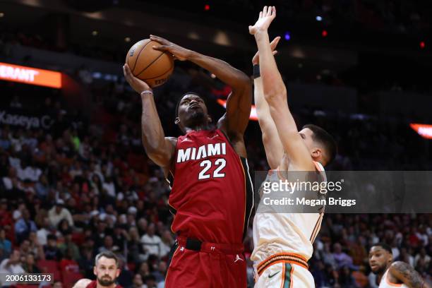 Jimmy Butler of the Miami Heat drives to the basket against Doug McDermott of the San Antonio Spurs during the second quarter of the game at Kaseya...