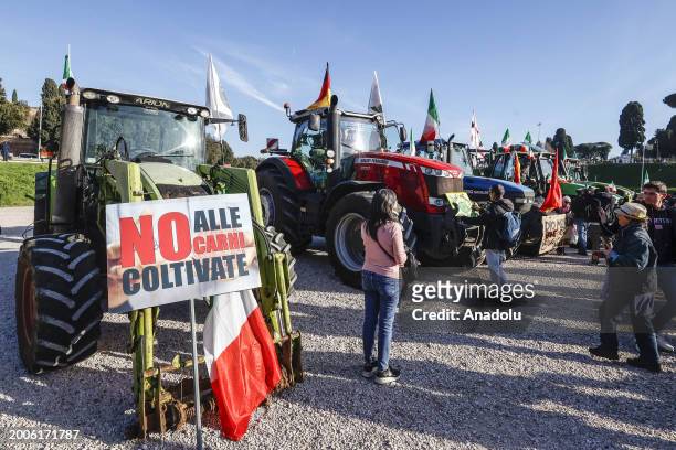 Sign reading 'No to cultivated meat' is seen near tractors at the Circus Maximus in Rome, Italy, on February 15, 2024. Although deeply divided,...