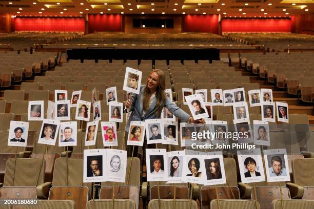Staff member lays out heads on sticks marking the seating plan during the "Heads On Sticks" photocall ahead of the EE BAFTA Film Awards 2024 at The...