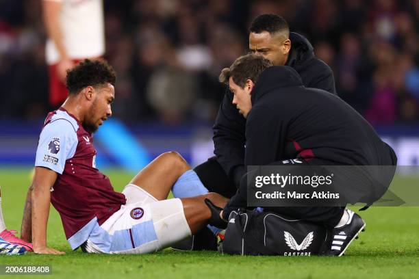 Boubacar Kamara of Aston Villa is treated for a knee injury before being substituted during the Premier League match between Aston Villa and...